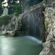 Cascade of thermal water at Villa dei Cedri Park, creating a soothing ambiance.