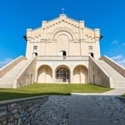 Sunlit facade of Madonna di Montecastello Sanctuary at Lake Garda.