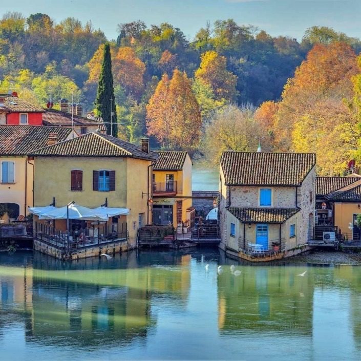 Scenic view of Borghetto sul Mincio, showcasing the medieval architecture surrounded by lush greenery.