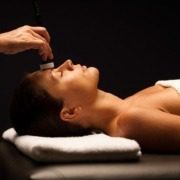 Woman enjoying a massage at Garda Thermae Spa near Lake Garda.