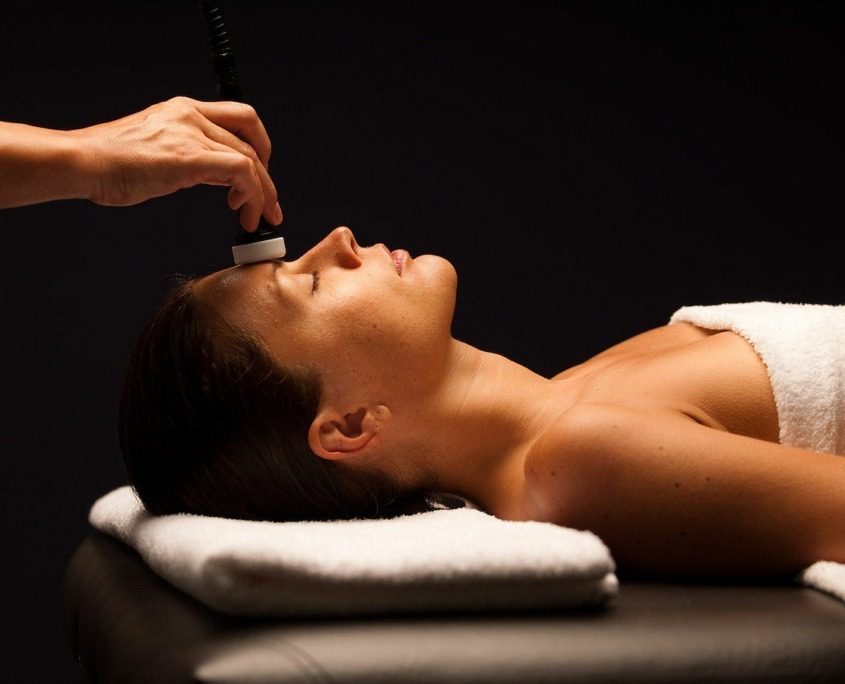 Woman enjoying a massage at Garda Thermae Spa near Lake Garda.