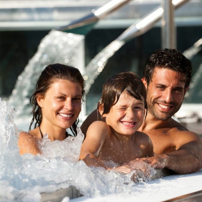 Family enjoying the facilities at Garda Thermae Spa near Lake Garda.