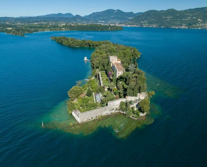 Aerial view of Isola del Garda surrounded by Lake Garda.