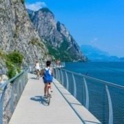 Girl riding bike on the cycling path of Limone sul Garda.