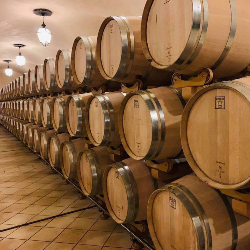 Cellar with many barrels of fine wine.