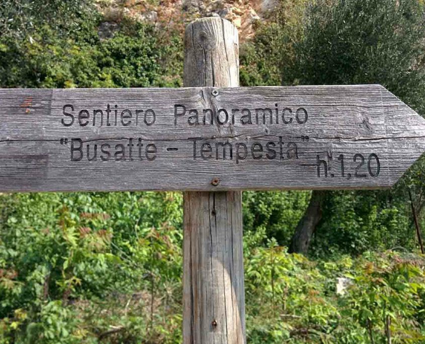 Wooden sign pointing to Busatte Tempesta Panoramic Path, Lake Garda