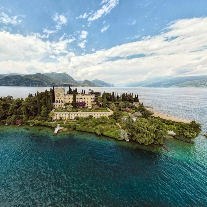 Aerial view showcasing Isola del Garda in the center of Lake Garda.