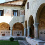 Courtyard view with photos on the wall in Madonna del Frassino Sanctuary in Peschiera del Garda.