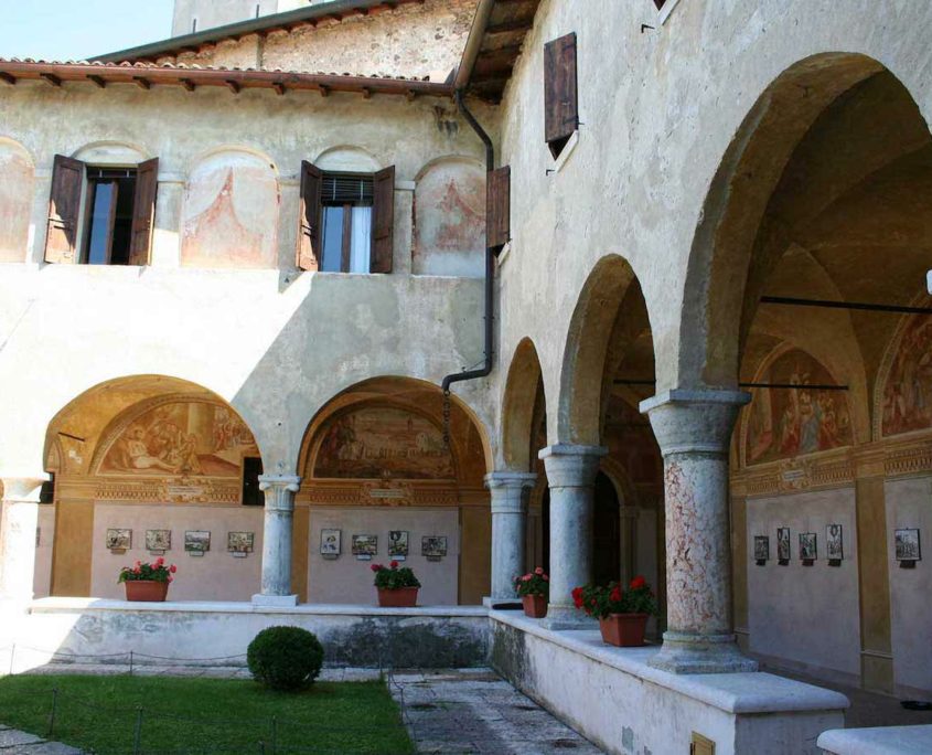 Courtyard view with photos on the wall in Madonna del Frassino Sanctuary in Peschiera del Garda.